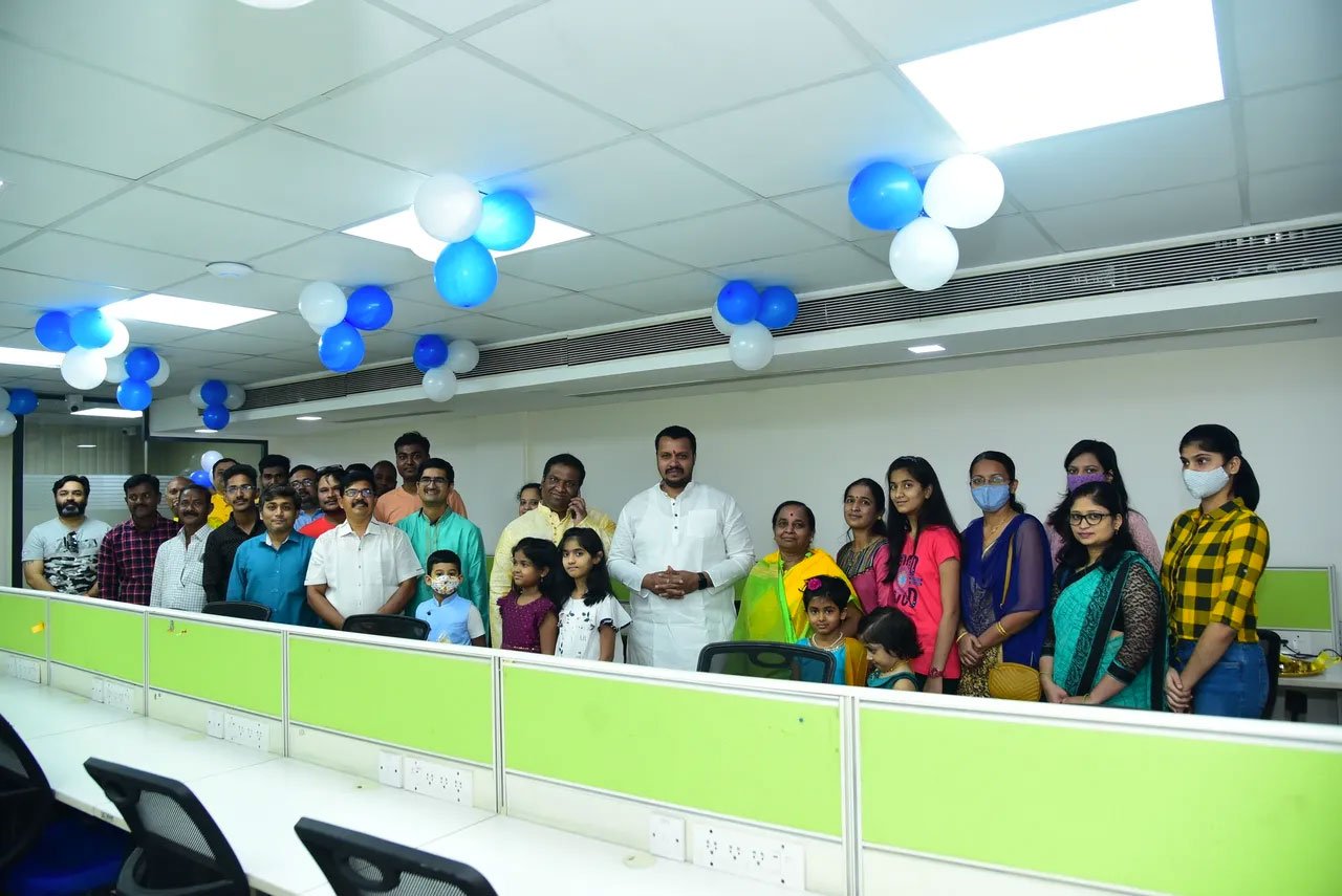 The team and their families in the new office space